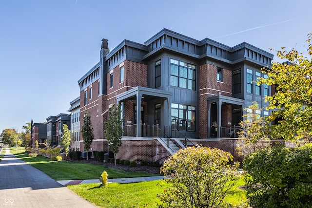 456 Monon Way Dr, Carmel, IN 46032 - view of front facade featuring brick siding, stairs, and a front yard