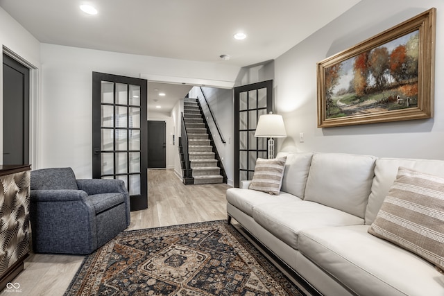 living room with french doors and light hardwood / wood-style flooring