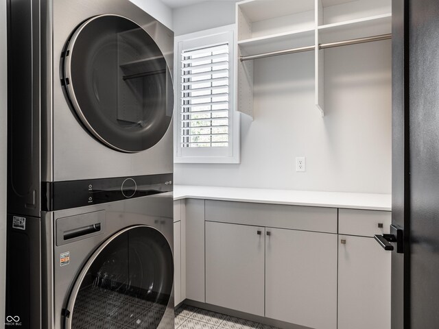 456 Monon Way Dr, Carmel, IN 46032 - clothes washing area featuring stacked washer and dryer and cabinet space