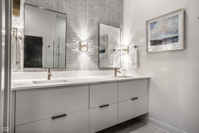 bathroom featuring vanity, decorative backsplash, and tile patterned floors