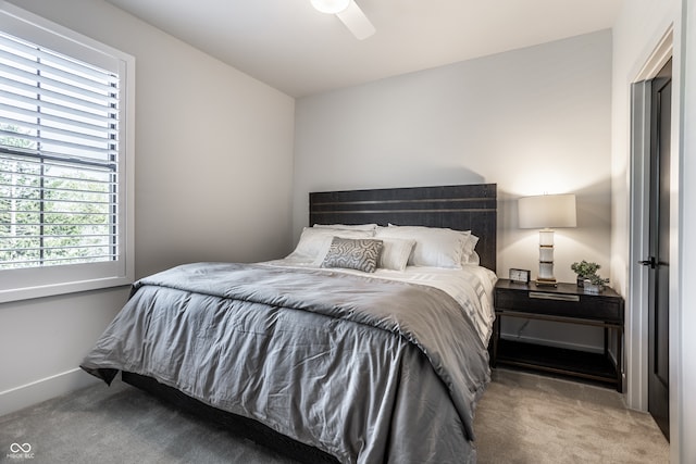 bedroom featuring multiple windows, carpet floors, and ceiling fan