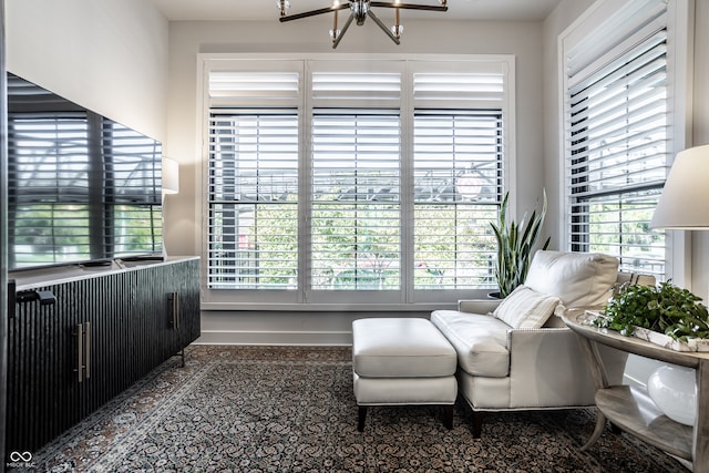 living area featuring an inviting chandelier and a healthy amount of sunlight