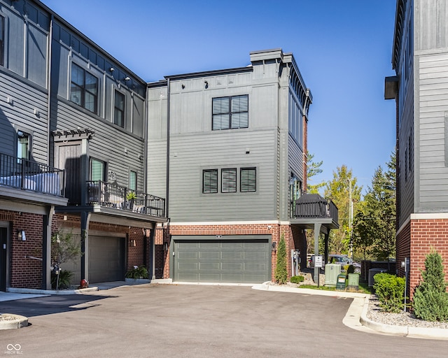 view of front of house featuring a garage and a balcony