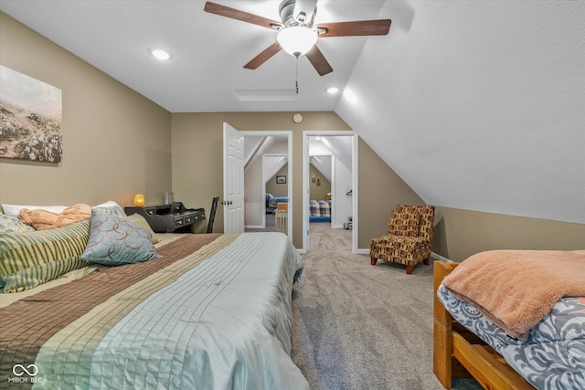 carpeted bedroom featuring lofted ceiling with skylight and ceiling fan