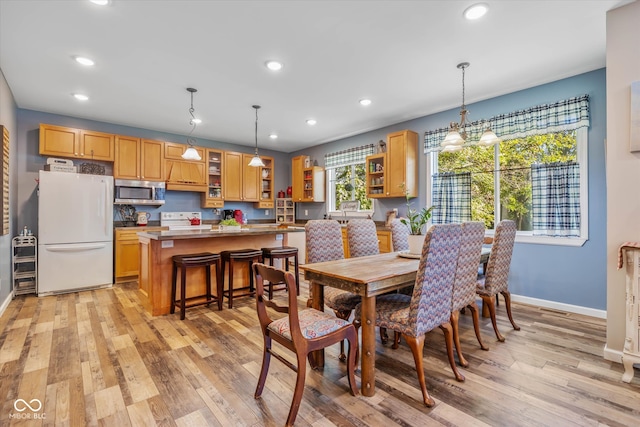 dining space featuring light wood-type flooring