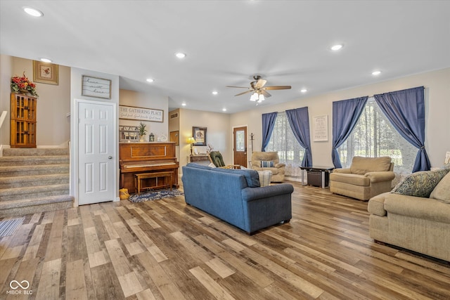 living room with hardwood / wood-style floors and ceiling fan