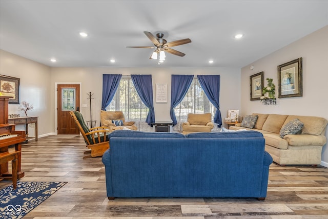 living room with hardwood / wood-style floors and ceiling fan