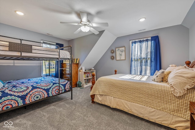 carpeted bedroom with vaulted ceiling, multiple windows, and ceiling fan