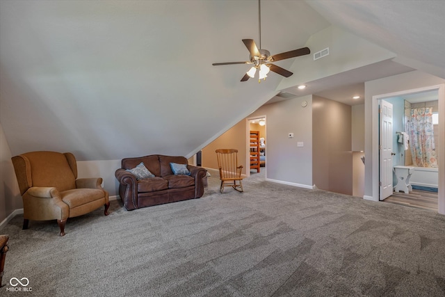 living room featuring ceiling fan, carpet flooring, and vaulted ceiling