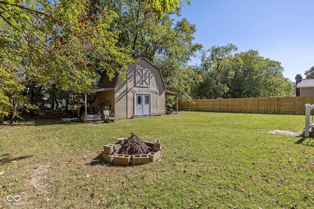 view of yard featuring a storage shed and a fire pit