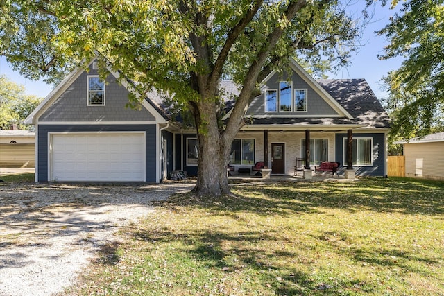 craftsman-style house featuring a front yard, a garage, and a porch