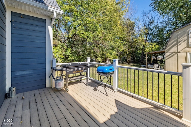 wooden terrace featuring a yard and grilling area