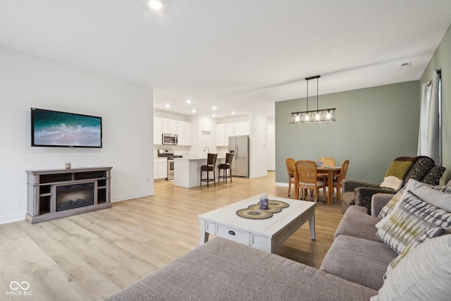 10008 Sundley Dr, Indianapolis, IN 46239 - living area featuring recessed lighting, baseboards, a chandelier, and light wood-type flooring