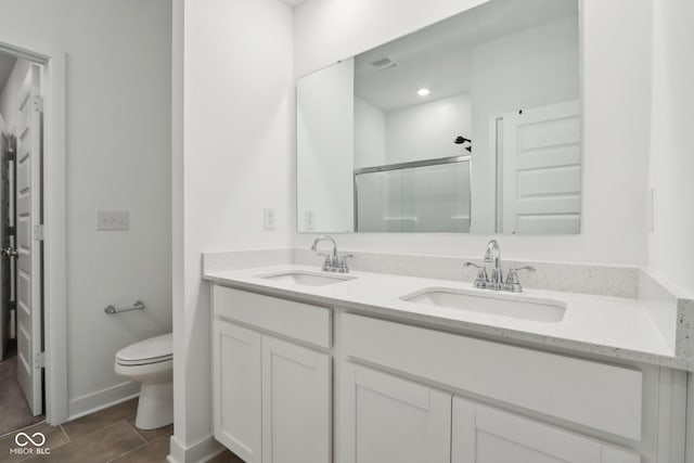 10008 Sundley Dr, Indianapolis, IN 46239 - bathroom featuring double vanity, a sink, toilet, and a shower stall