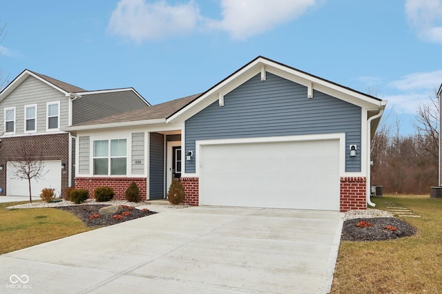 10008 Sundley Dr, Indianapolis, IN 46239 - view of front of property featuring brick siding, concrete driveway, central air condition unit, and an attached garage