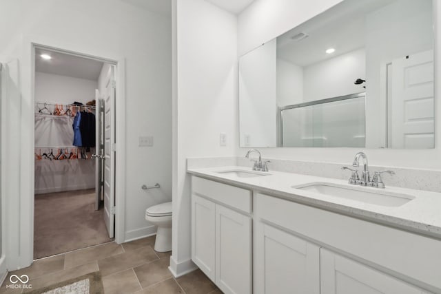 10008 Sundley Dr, Indianapolis, IN 46239 - bathroom with a stall shower, double vanity, toilet, and a sink