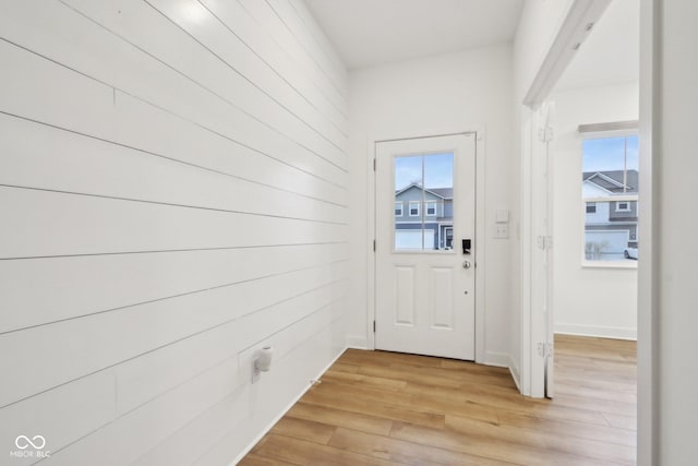 10008 Sundley Dr, Indianapolis, IN 46239 - doorway to outside featuring baseboards and light wood finished floors