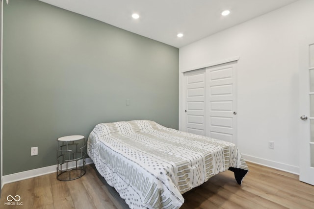 10008 Sundley Dr, Indianapolis, IN 46239 - bedroom with baseboards, a closet, wood finished floors, and recessed lighting