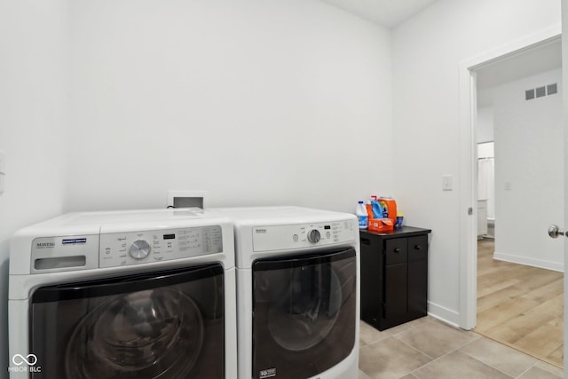 10008 Sundley Dr, Indianapolis, IN 46239 - laundry area featuring laundry area, light tile patterned floors, baseboards, visible vents, and washer and dryer