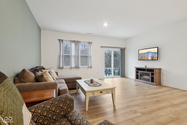 10008 Sundley Dr, Indianapolis, IN 46239 - living area with baseboards, a fireplace, visible vents, and light wood-type flooring