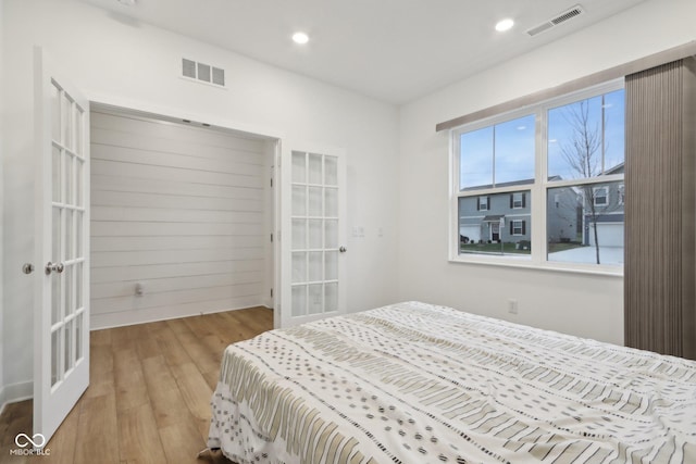 10008 Sundley Dr, Indianapolis, IN 46239 - bedroom with light wood finished floors, visible vents, and french doors