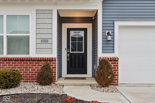 10008 Sundley Dr, Indianapolis, IN 46239 - property entrance featuring brick siding and a garage