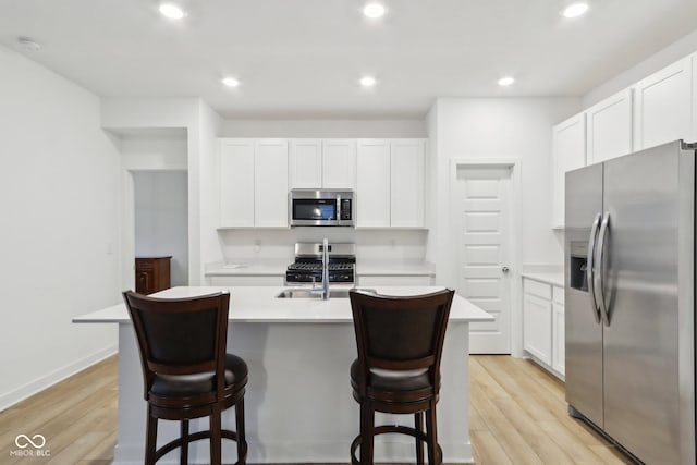 10008 Sundley Dr, Indianapolis, IN 46239 - kitchen with light countertops, stainless steel appliances, white cabinets, and light wood finished floors
