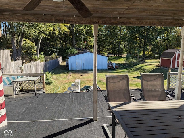 view of patio / terrace featuring ceiling fan and a storage shed