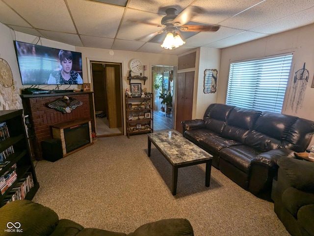 living room featuring carpet, a paneled ceiling, and ceiling fan