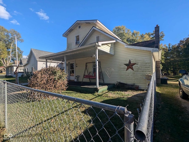 view of front of house with fence private yard, covered porch, and a front yard
