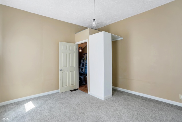 unfurnished bedroom with carpet floors and a textured ceiling