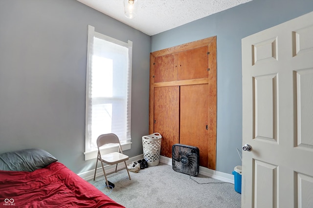 bedroom with a textured ceiling and carpet floors