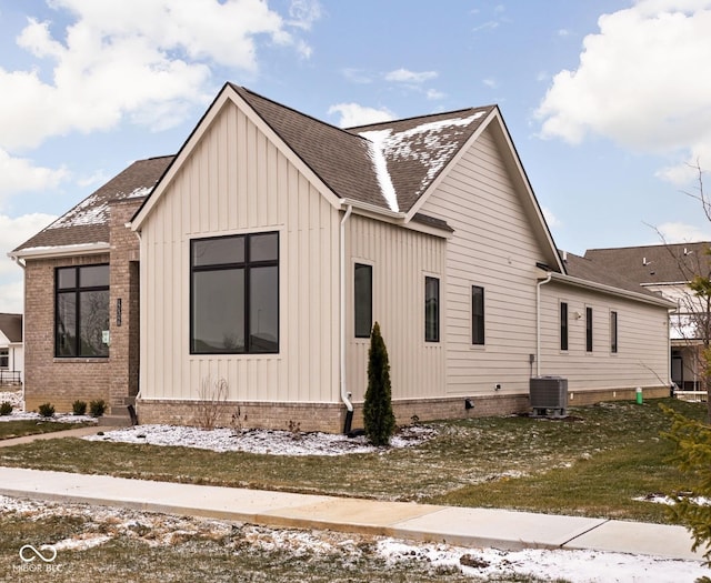 view of snowy exterior featuring cooling unit