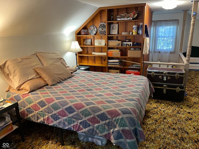 bedroom featuring lofted ceiling and carpet floors