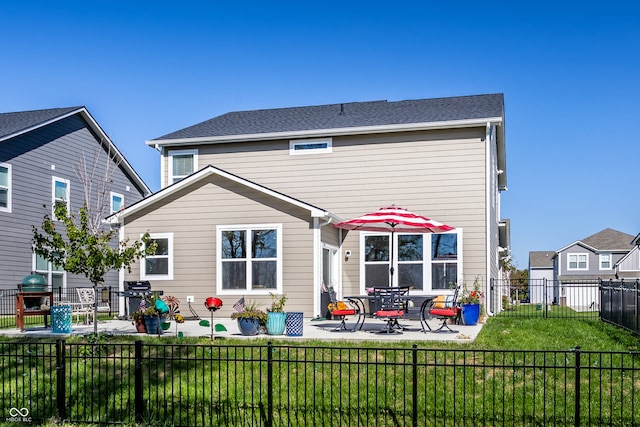 back of house with a patio area and a lawn