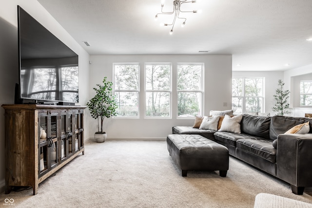 living room featuring a notable chandelier and light carpet