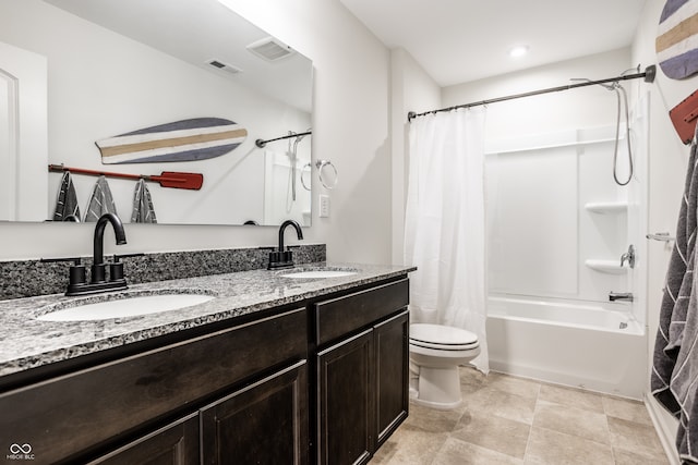 full bathroom featuring toilet, vanity, and shower / tub combo