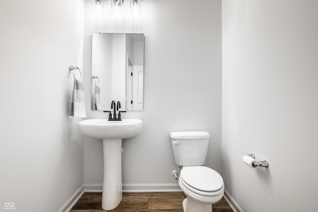 bathroom featuring toilet, hardwood / wood-style flooring, and sink