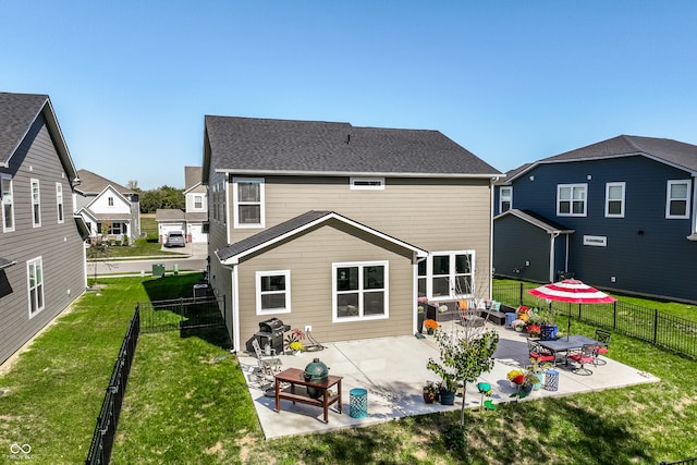 back of property featuring a patio area and a yard