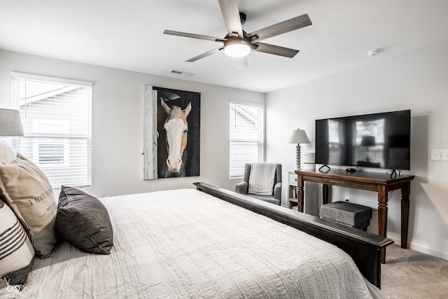 bedroom featuring light colored carpet and ceiling fan