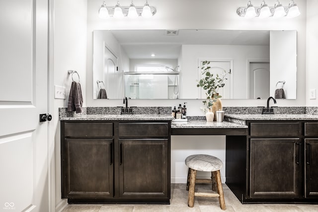 bathroom with vanity, an enclosed shower, and tile patterned floors