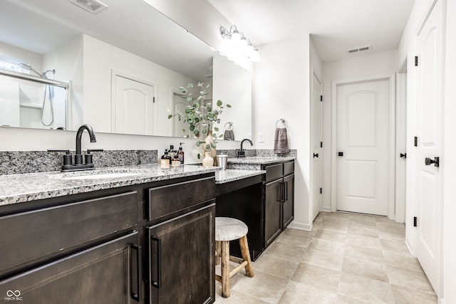 bathroom with vanity, tile patterned floors, and a shower with door