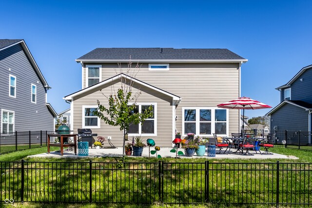 rear view of house with a patio and a lawn