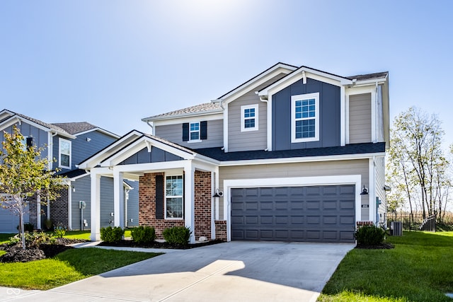 view of front of house featuring central air condition unit, a front yard, and a garage