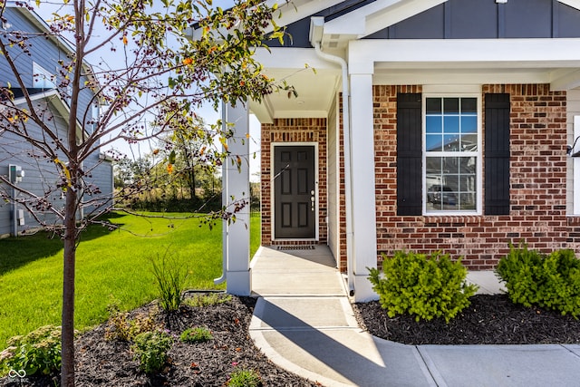 entrance to property with a lawn