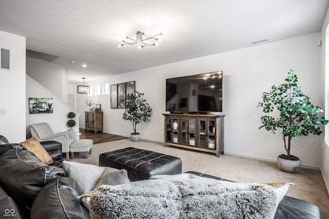 living room with a chandelier and carpet floors