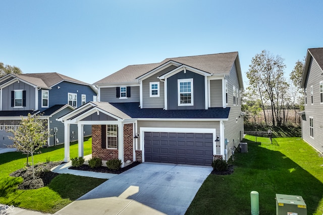 view of front of house featuring cooling unit, a front yard, and a garage