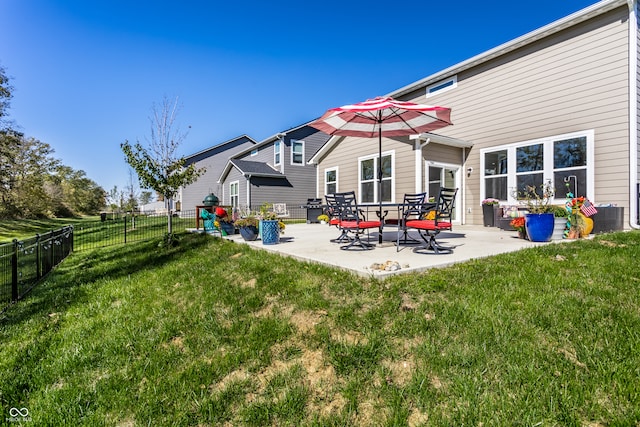 back of house with a yard and a patio area