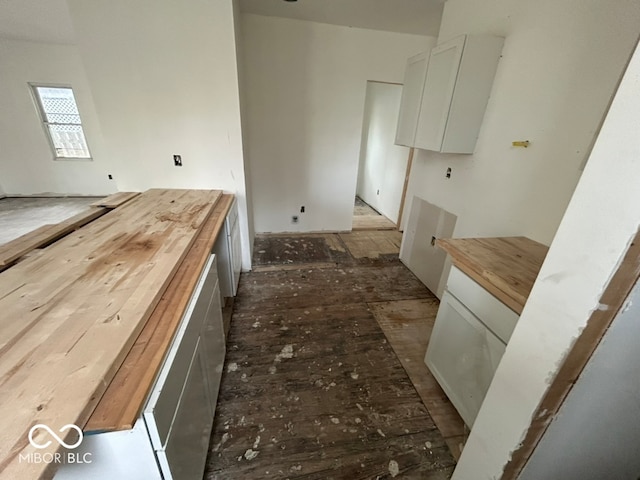 kitchen featuring white cabinets and butcher block countertops