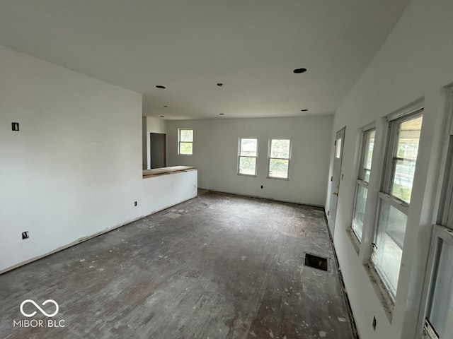 unfurnished living room featuring lofted ceiling